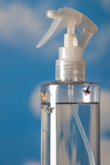 A Whimsical Scene: Spray Bottle with Tiny Mushrooms and Butterflies