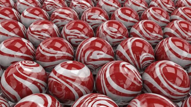 A close-up arrangement features countless spherical candies, showcasing a red and white spiral design