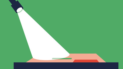 A spotlight illuminates a small green object on a red surface, set against a green background.