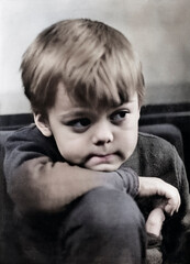 Vintage portrait of a sweet, thoughtful, and enthusiastic little boy. Retro photo from 1972.