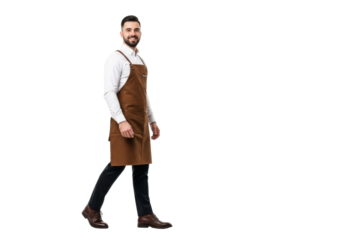 Young caucasian man, 25-30, in white shirt, brown canvas apron, and dark trousers, walking mid-stride, smiling professionally on transparent studio background with copy space, concept for service