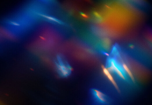 Abstract colorful light reflections with soft bokeh patterns on a dark surface, creating a dreamy luminous texture ideal for design backgrounds, technology visuals, and branding