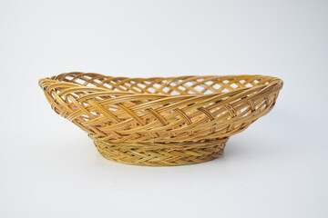 Handcrafted empty brown wicker basket made of natural rattan, isolated on white background