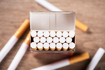 Close up of open pack of cigarettes on table