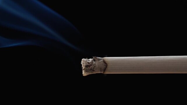 Cigarette smoking closeup isolated on black background