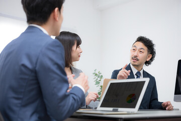 Businessmen holding a meeting in a conference room A male executive explaining a plan Image of a strategy meeting