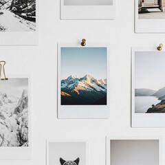 Curated Wall Display of Instant Photos Featuring Majestic Snowy Mountains and Serene Landscapes
