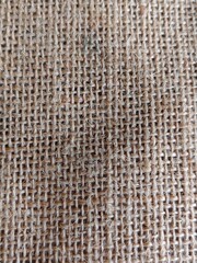 Light brown burlap fabric surface.
