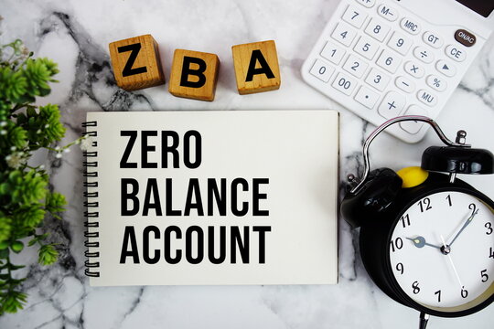 ZBA Zero Balance Account text with calculator and alarm clock on marble background