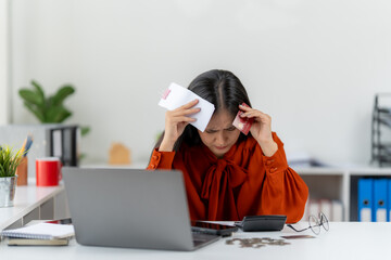 Financial Stress: An individual struggles under the weight of financial burden, surrounded by bills and documents, showcasing the pressures of modern-day economic realities.