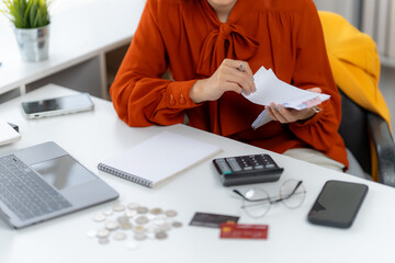 Budgeting and Financial Planning: A woman meticulously examines financial documents, amidst a modern office setting, planning a successful economic future. 