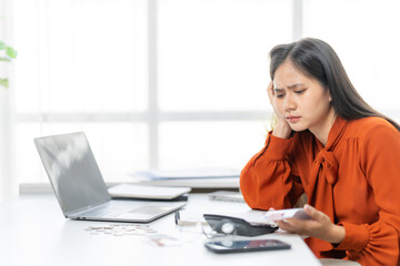 Overwhelmed by Finances: A woman struggles with financial management and expenses, reflecting the weight of financial stress and responsibility.