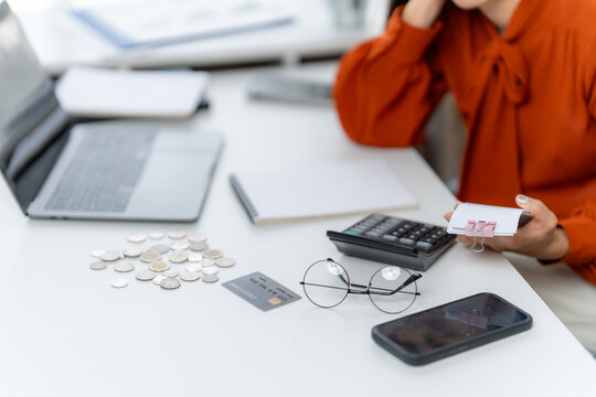 Financial Frustration: A person, surrounded by financial tools, grapples with the complexities of budgeting and personal finance, highlighting the emotional strain of money matters.
