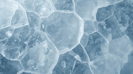 Fototapeta premium Frozen lake surface with cracked ice formations in shades of blue