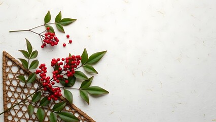 Red berry branches on a woven whisk against a white background berries leaves green