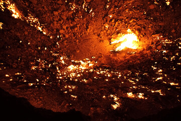 Burning Darvaza gas crater in Karakum Desert at sunset, natural fire pit in Turkmenistan. g.