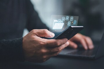Businessman holding smartphone with virtual folder and digital documents for data management