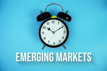 Emerging Markets text and alarm clock on blue background