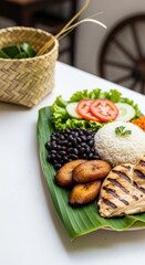 Steaming Colorful Costa Rican Casado Plate with Grilled Chicken in Banana Leaf and Left Negative Space