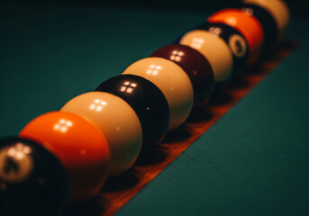 Close up view of colorful pool billiard balls lined up on green felt table