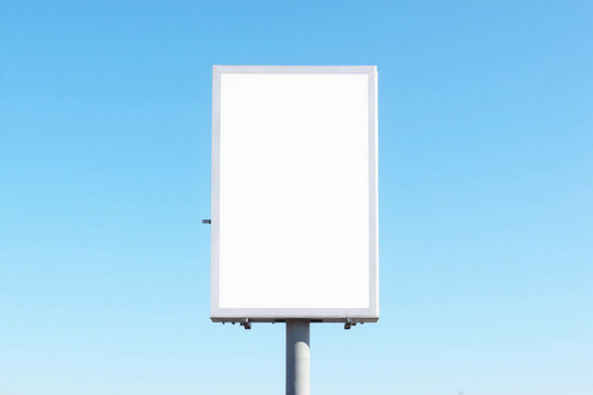Outdoor pole vertical light box billboard on blue sky background with mock up white screen. Clipping path for mockup. 3d rendering.