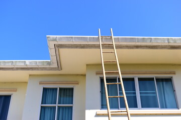 wood ladder for repair house's gutter before rainy season