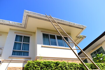 wood ladder for repair house's gutter before rainy season