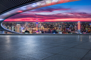 Empty square floor and city skyline with modern buildings at night in Shanghai