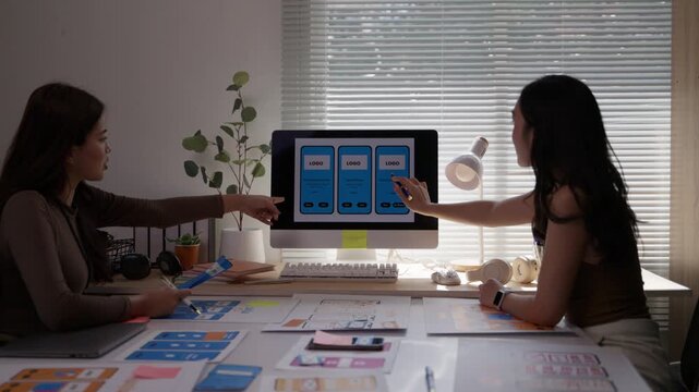 Creative team of female developers planning application and developing wireframe. UX/UI designers working on a new website layout together