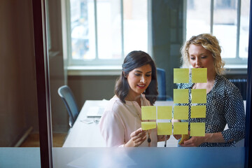 Women, sticky note or glass wall in office for timeline, business development or campaign planning. Creative team, discussion or moodboard in firm for workflow, productivity agenda or brainstorming