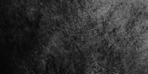 Fototapeta premium A close up monochromatic view of a heavily textured dark surface resembling rough stone or weathered material