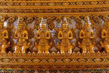 Fototapeta premium Praying statues part of the Interior design, replica of the Sanphet Prasat Palace, at Muang Boran, in Samut Prakan, Thailand. 