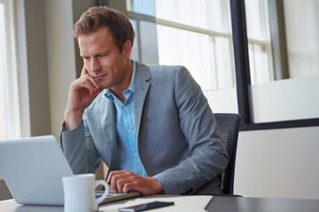 Naklejka premium Man, thinking and laptop in office for investment, trading opportunity and news for increase in market value. Trader, computer or reading in agency for crypto finance, account management or goal idea