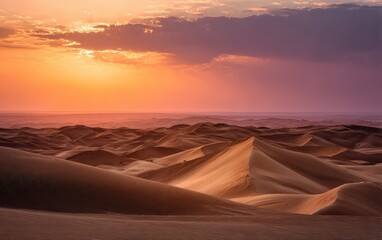 Breathtaking Desert Sunset Golden Light Illuminating Vast Sand Dunes with Dramatic Orange, Pink, and Purple Sky at Dusk.