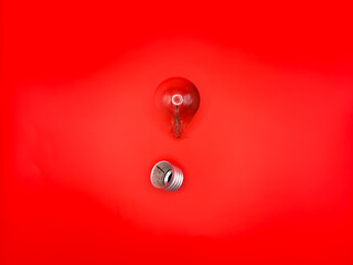 Tungsten light bulb lamp. Non-working light bulb, broken light bulb. Concept of light and dark, idea, electricity copy space, flay lay, top view red background. High quality