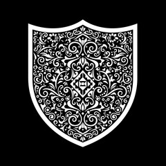 Intricate Ornate Shield with Detailed Floral and Scrollwork Pattern.