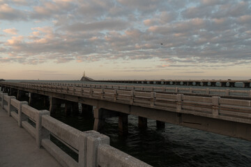 Sunset View Along Pier With Skyway Bridge in Distance