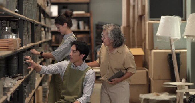In a family business, a mother, son, and daughter manage a ceramic shop together, arranging tableware displays and coordinating daily operations for both retail and wholesale sales.
