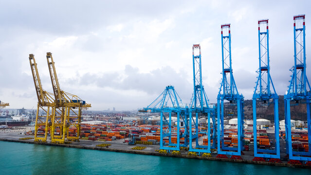 Barcelona, Spain - December 19, 2025: Cranes in the container terminal in port of Barcelona