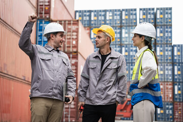 Engineer and worker team working in logistic terminal of container cargo, Diverse construction team in safety gear outdoors