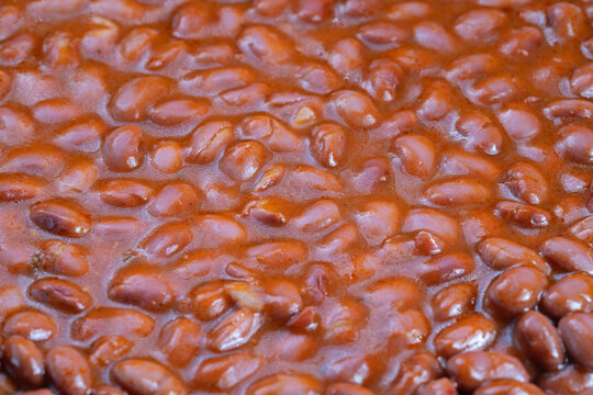 Instant baked beans with sauce, Delicious seasoned baked beans served in convenient can, Speedy meal option featuring shiny baked beans perfect for hectic kitchen settings