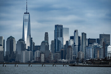 Fototapeta premium New York Manhattan skyscrapers reflecting blue sky. New York NYC skyscrapers along the waterfront. New York skyline panoramic view. New York Manhattan cityscape with modern architecture.