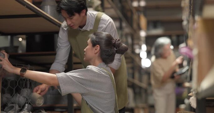 In a family business, a mother, son, and daughter manage a ceramic shop together, arranging tableware displays and coordinating daily operations for both retail and wholesale sales.
