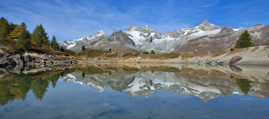 Mountains Gabelhorn, Trifthorn and Zinalrothorn mirrorin in Lake Gruensee, Zermatt, Switzerland.