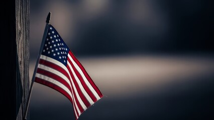 American flag on pole near weathered wood, blowing in wind with blurred background