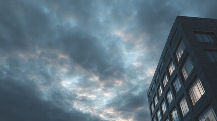 an exterior shot of a modern dark building at dusk with the sky showing a dynamic cloudscape 