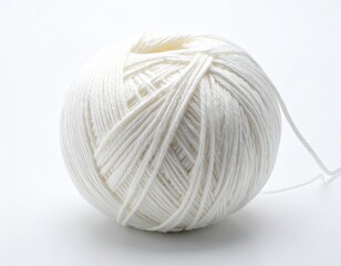 Close-up of a ball of tightly wound white yarn, studio shot