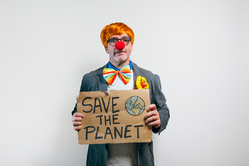Clown holding save the planet sign on white background