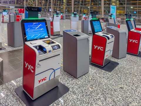 Calgary, Alberta, Canada. Dec 27, 2025. Automated YYC Airport Self-Service Check-in Kiosks with Digital Displays in Calgary