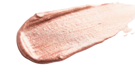 A smooth, shimmering swatch of rose gold makeup product, showcasing a creamy texture and reflective finish.